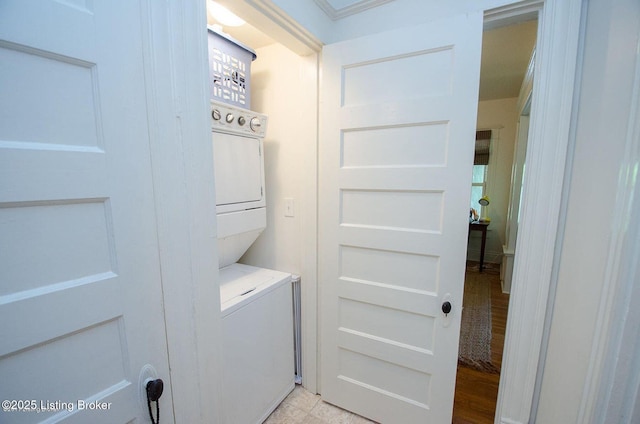 laundry area with stacked washer / dryer and laundry area