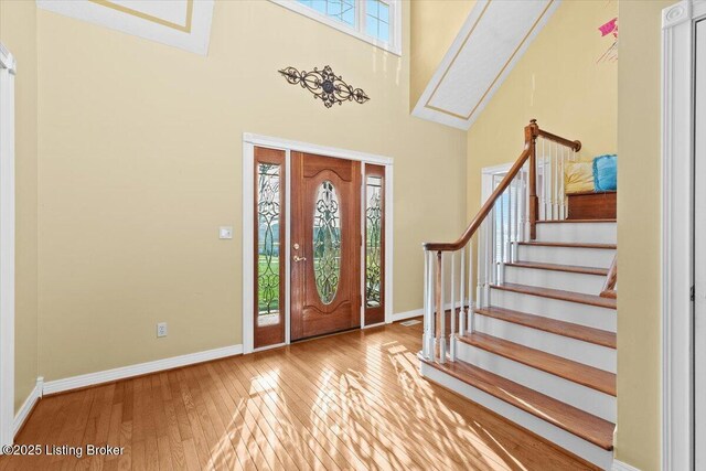 235 Ashford Dr, Mt Washington, KY 40047 - foyer entrance with a skylight, hardwood / wood-style flooring, baseboards, stairway, and a high ceiling