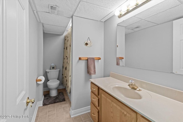 235 Ashford Dr, Mt Washington, KY 40047 - full bath featuring toilet, vanity, tile patterned floors, baseboards, and a drop ceiling
