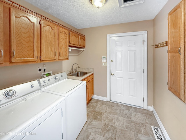 235 Ashford Dr, Mt Washington, KY 40047 - laundry area with cabinet space, washing machine and clothes dryer, baseboards, and a textured ceiling