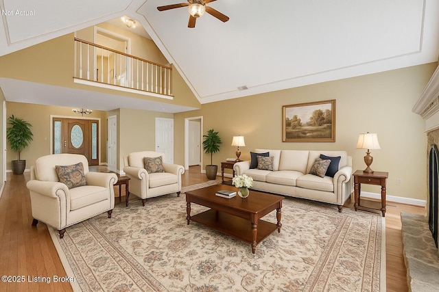 235 Ashford Dr, Mt Washington, KY 40047 - living area featuring light wood-style floors, ceiling fan, baseboards, high vaulted ceiling, and a fireplace