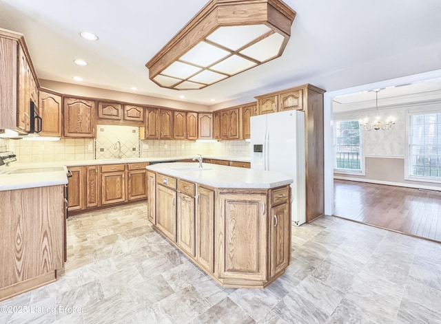 235 Ashford Dr, Mt Washington, KY 40047 - kitchen featuring white fridge with ice dispenser, a chandelier, a sink, an island with sink, and light countertops