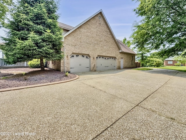 235 Ashford Dr, Mt Washington, KY 40047 - view of side of home with driveway, brick siding, and a garage