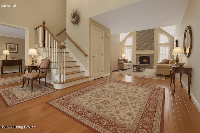 235 Ashford Dr, Mt Washington, KY 40047 - living area featuring high vaulted ceiling, hardwood / wood-style flooring, stairs, a fireplace, and baseboards
