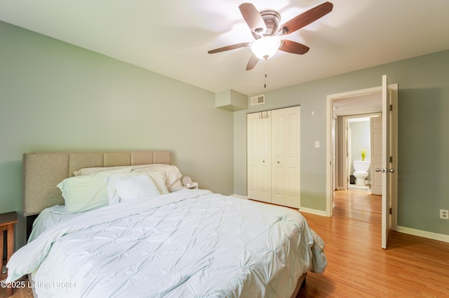 bedroom with a ceiling fan, visible vents, baseboards, a closet, and light wood finished floors