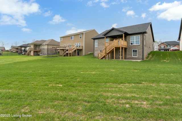 382 Williamsburg Dr, Mt Washington, KY 40047 - back of house with a trampoline, a lawn, stairs, and a deck