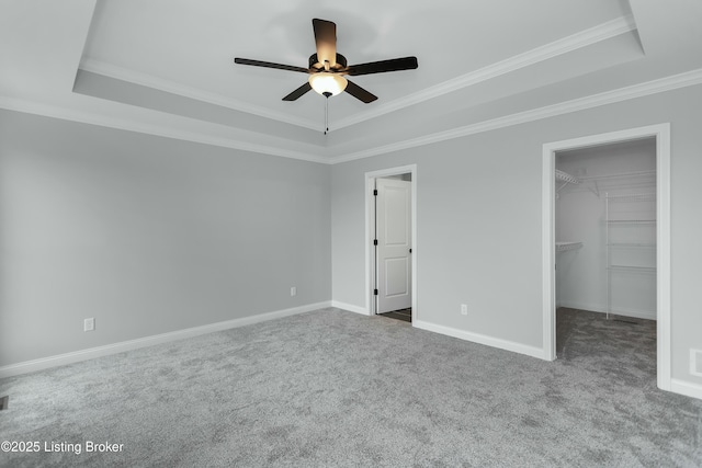 382 Williamsburg Dr, Mt Washington, KY 40047 - unfurnished bedroom featuring a walk in closet, a tray ceiling, and carpet
