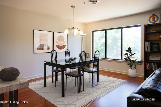 1611 Spring Dr Unit 5C, Louisville, KY 40205 - dining space featuring a chandelier, baseboards, and light wood-type flooring