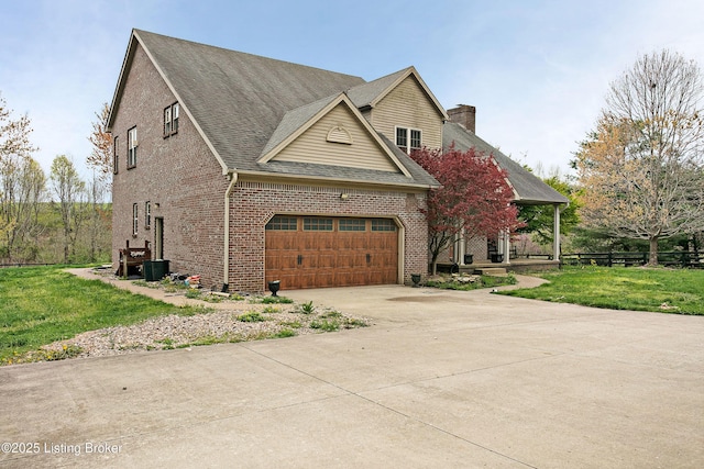 view of front of house featuring brick siding, driveway, a front lawn, and fence