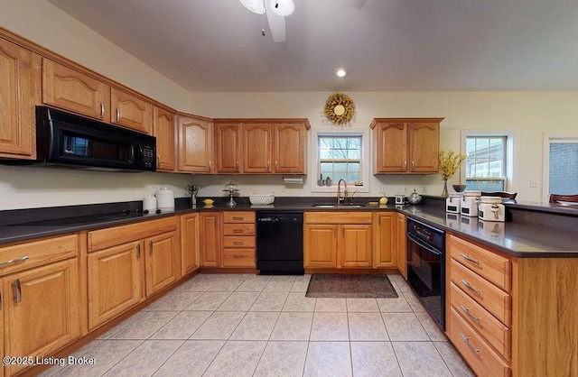 kitchen with a healthy amount of sunlight, light tile patterned floors, a sink, black appliances, and a peninsula