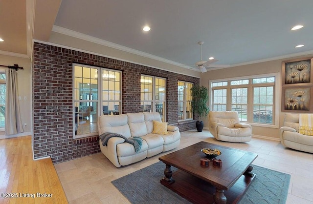 living area featuring baseboards, recessed lighting, ceiling fan, and crown molding