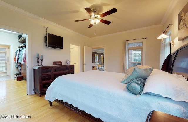 bedroom with light wood finished floors, ceiling fan, and ornamental molding