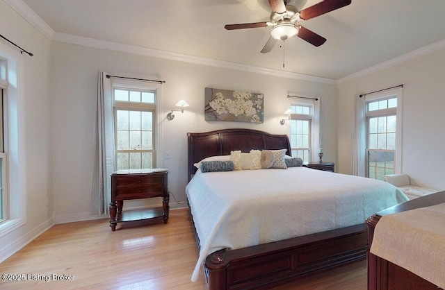 bedroom with ceiling fan, baseboards, crown molding, and light wood-style flooring