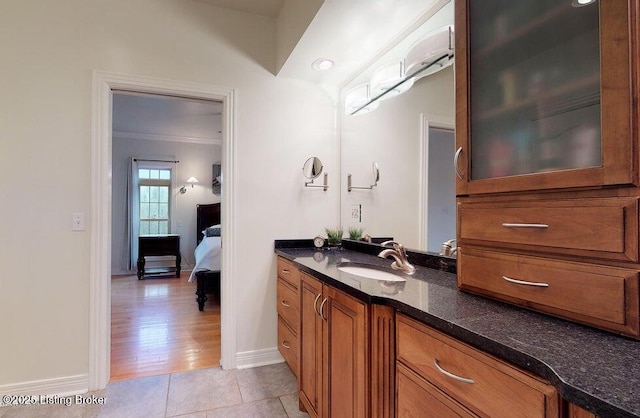 bathroom with vanity, baseboards, ensuite bath, ornamental molding, and tile patterned flooring