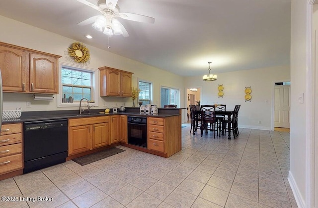 kitchen with dark countertops, a sink, light tile patterned flooring, black appliances, and a peninsula