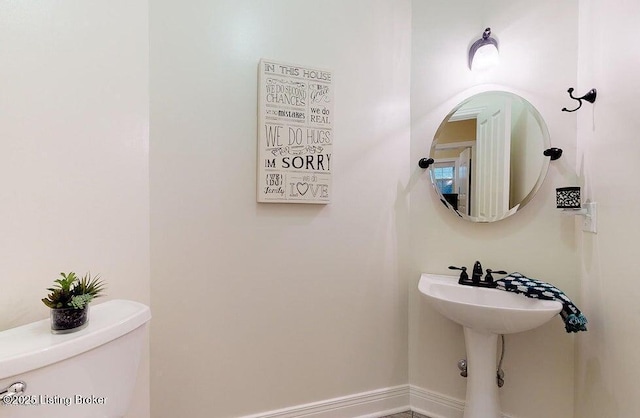 half bathroom featuring toilet