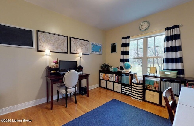 office area featuring baseboards and wood finished floors