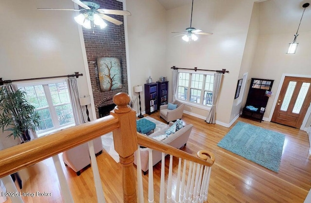 living area featuring a ceiling fan and a towering ceiling