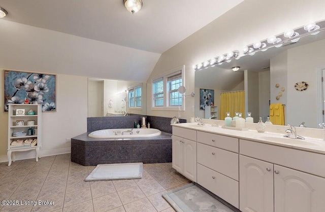 full bathroom featuring vaulted ceiling, a sink, a bath, double vanity, and tile patterned flooring