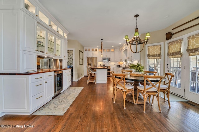 4232 Ashleywood Ct, Louisville, KY 40241 - dining area with wine cooler, an inviting chandelier, and dark wood-style floors
