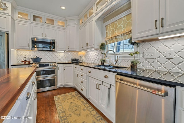 4232 Ashleywood Ct, Louisville, KY 40241 - kitchen featuring butcher block countertops, dark wood-style flooring, white cabinetry, appliances with stainless steel finishes, and a sink