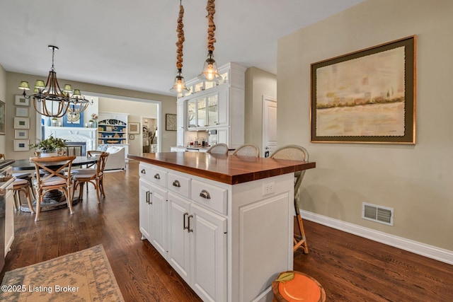 4232 Ashleywood Ct, Louisville, KY 40241 - kitchen featuring butcher block countertops, dark wood-style flooring, a chandelier, white cabinetry, and visible vents