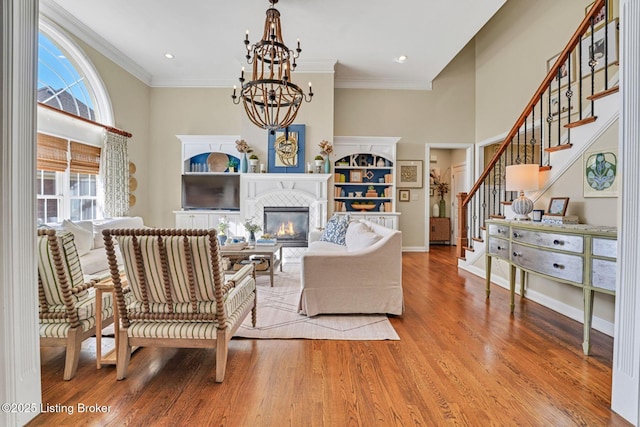 4232 Ashleywood Ct, Louisville, KY 40241 - living room with ornamental molding, a chandelier, stairway, wood finished floors, and a glass covered fireplace