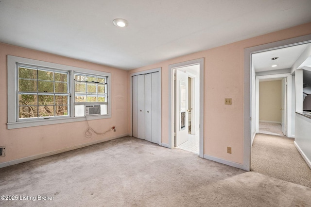 unfurnished bedroom featuring a closet, baseboards, and carpet floors