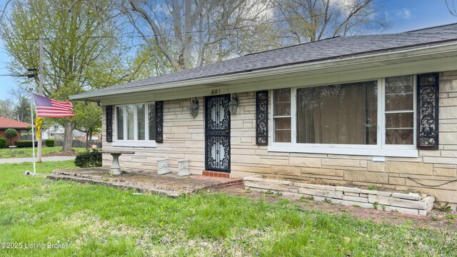 901 S 47th St, Louisville, KY 40211 - view of front of property with a shingled roof, stone siding, and a front lawn
