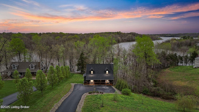 bird's eye view with a water view and a wooded view