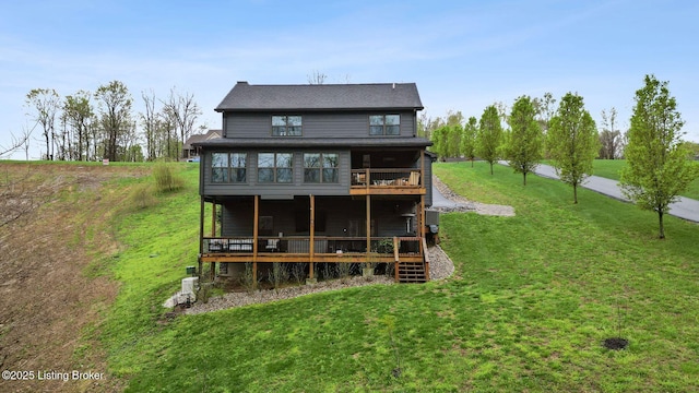 back of house featuring a deck and a lawn