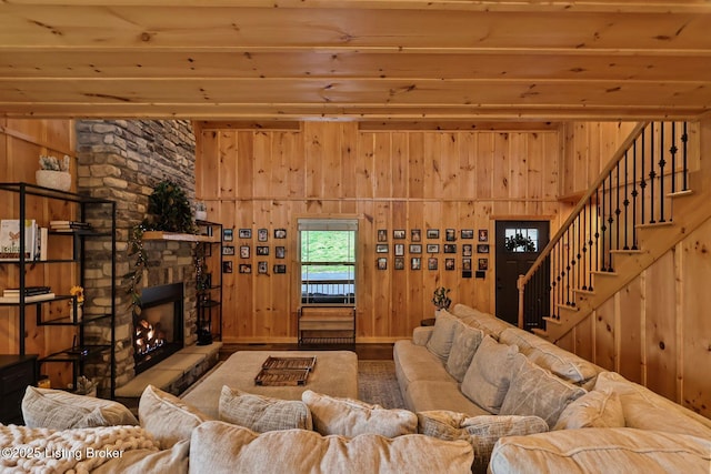 living room featuring wood walls and stairway