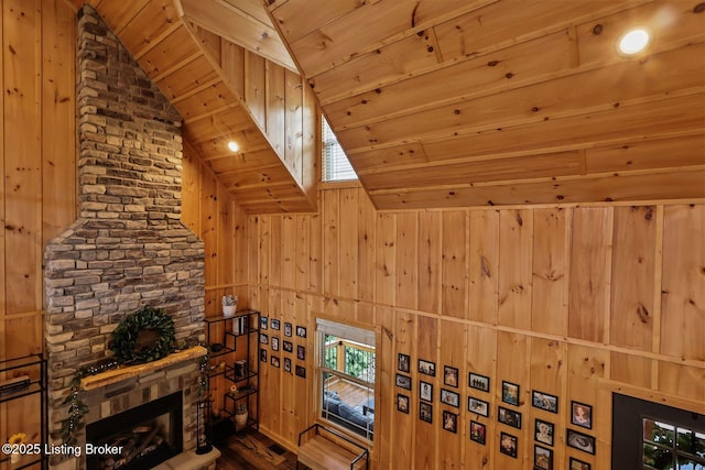 interior space with wood walls, wooden ceiling, and vaulted ceiling