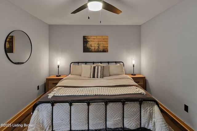 bedroom featuring baseboards, ceiling fan, and wood finished floors