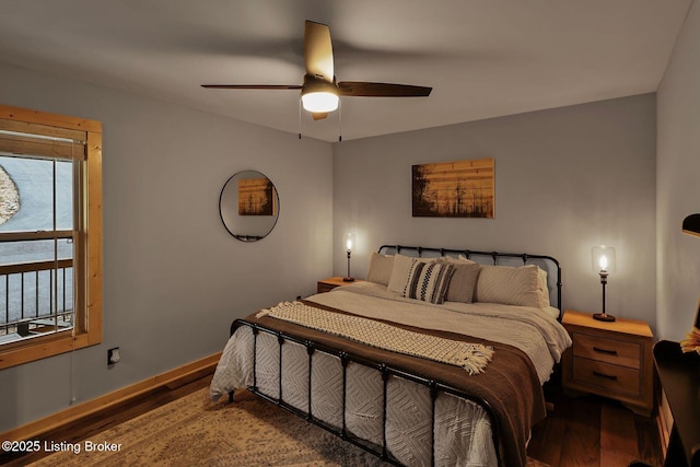 bedroom featuring baseboards, ceiling fan, and wood finished floors