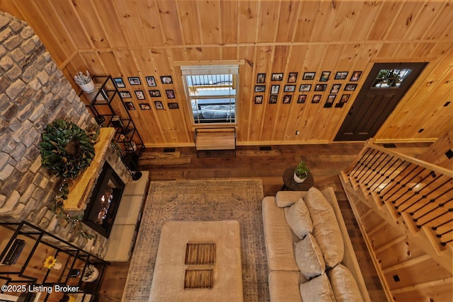 interior space featuring wooden walls, wood-type flooring, and wooden ceiling
