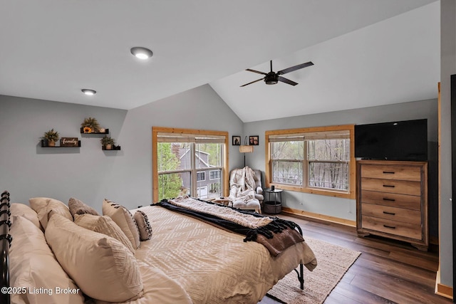 bedroom with wood finished floors, baseboards, a ceiling fan, and vaulted ceiling