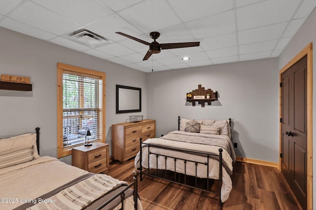 bedroom with visible vents, ceiling fan, a paneled ceiling, and wood finished floors