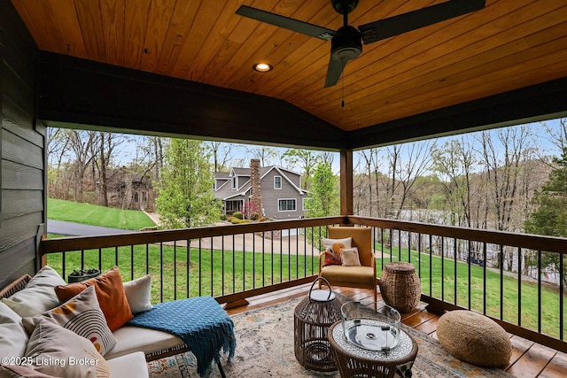 deck with an outdoor living space, a yard, and a ceiling fan