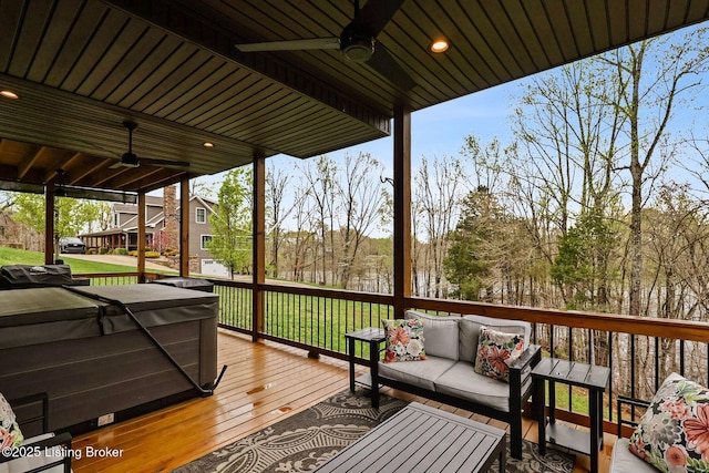 wooden deck with a ceiling fan and an outdoor hangout area