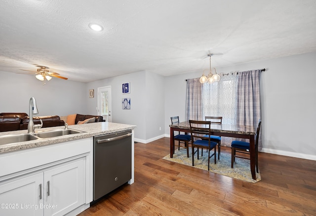 kitchen with plenty of natural light, dishwasher, baseboards, and a sink