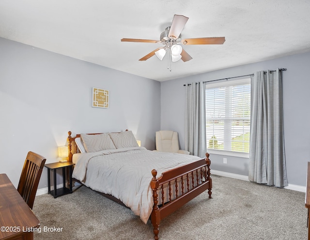 bedroom featuring light carpet, baseboards, and a ceiling fan