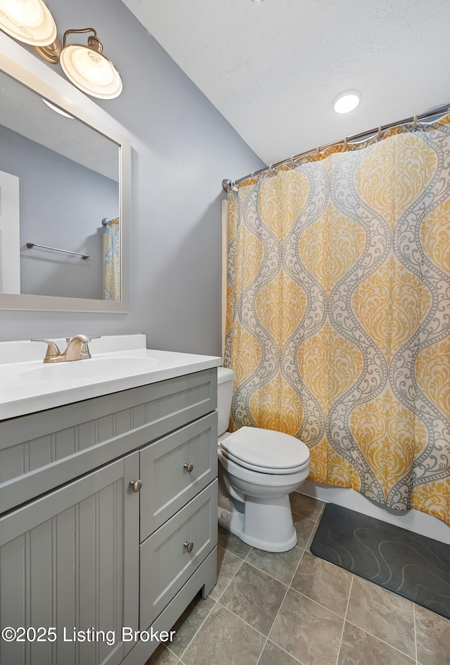 full bathroom with tile patterned floors, toilet, and vanity
