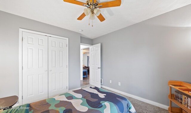 carpeted bedroom featuring a closet, baseboards, and ceiling fan