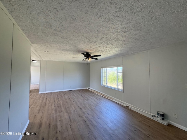 490 Blackjack Rd, Radcliff, KY 40160 - empty room featuring wood finished floors, a textured ceiling, ceiling fan, and baseboards
