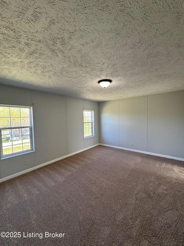 490 Blackjack Rd, Radcliff, KY 40160 - empty room with dark colored carpet, baseboards, and a textured ceiling