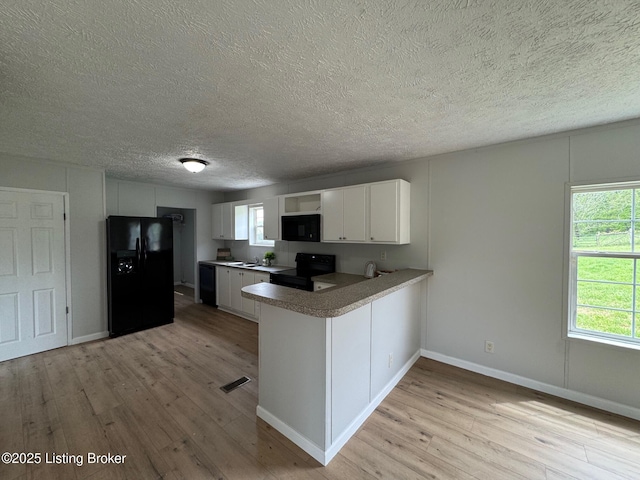 490 Blackjack Rd, Radcliff, KY 40160 - kitchen featuring black appliances, light wood-type flooring, white cabinets, a peninsula, and a textured ceiling