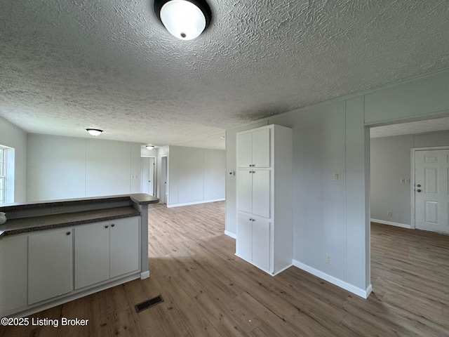 490 Blackjack Rd, Radcliff, KY 40160 - spare room with wood finished floors, a textured ceiling, and baseboards