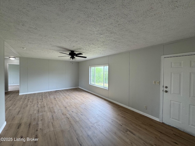 490 Blackjack Rd, Radcliff, KY 40160 - unfurnished room featuring wood finished floors, a ceiling fan, a textured ceiling, and baseboards
