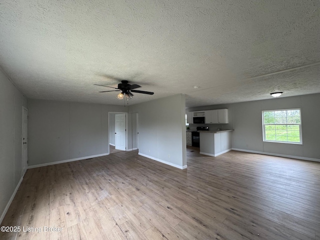 490 Blackjack Rd, Radcliff, KY 40160 - unfurnished living room featuring a textured ceiling, wood finished floors, and baseboards